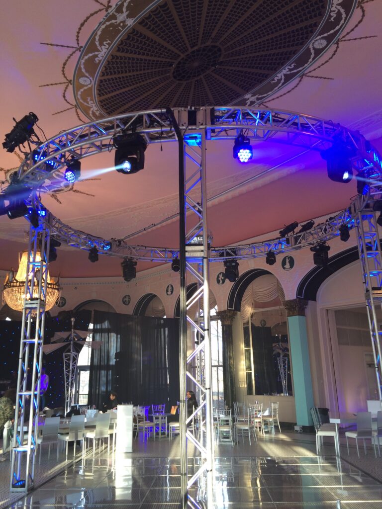 Ground-supported silver circle truss with lighting